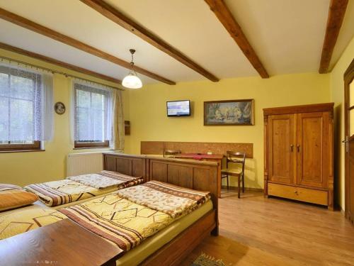 a bedroom with two beds and a desk in it at Kwatery Prywatne-Willa "Nadzieja" in Świeradów-Zdrój