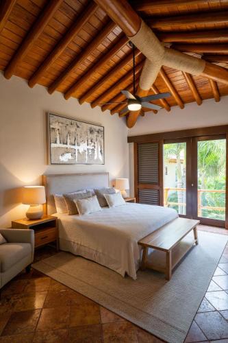 a bedroom with a large bed and a ceiling at Jaguar. Beach Facing House (10 steps) - Bucerías in Bucerías