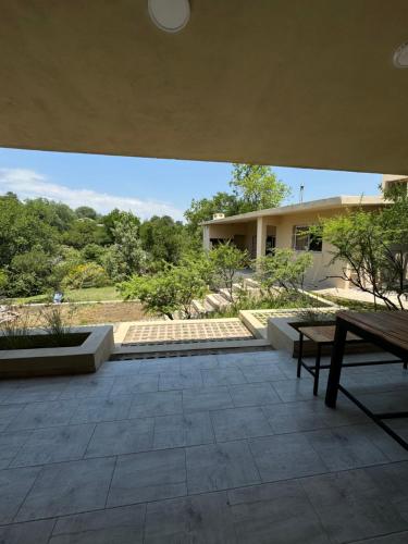 a patio with a wooden bench and a building at Cabañas Cuesta in Cordoba