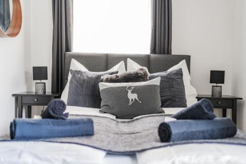 a bedroom with a bed with pillows on it at Innsbruck City Chalet in Innsbruck