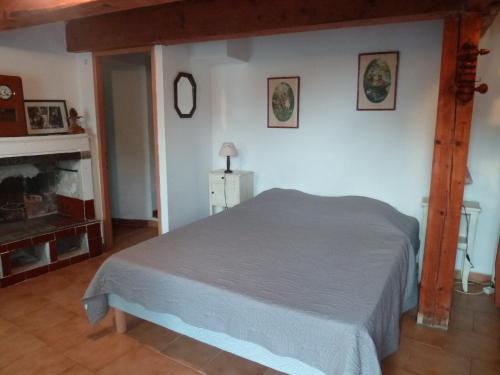une chambre avec un lit et une cheminée dans l'établissement Maison de charme près de la mer, à Bormes-les-Mimosas