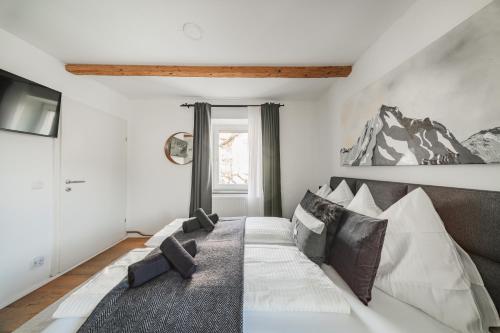 a bedroom with a large bed with a couch at Innsbruck City Chalet in Innsbruck