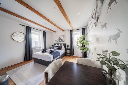 a living room with a bed and a table at Innsbruck City Chalet in Innsbruck