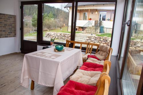 a white table and chairs in a room with a window at Casa Ana in Câmpulung Moldovenesc
