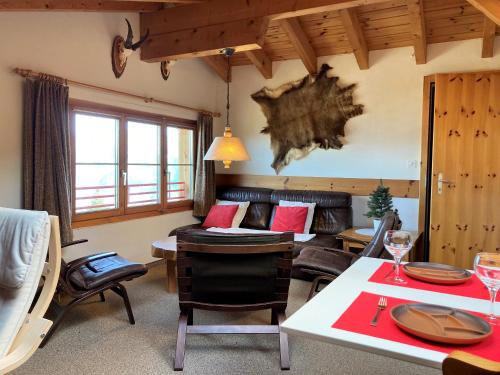 a living room with a couch and a table at Haus Primula Pizol in Wangs