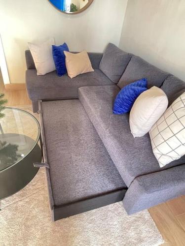 a couch with pillows on it in a living room at Acogedora partamento cerca de la embajada in Santo Domingo