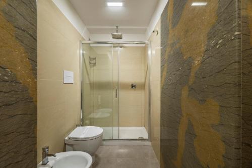 a bathroom with a shower and a toilet and a sink at B&B Cantiere dell'anima - Rooms of art in Trapani