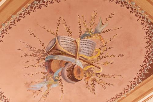 a painting of a chandelier with books on a wall at B&B Cantiere dell'anima - Rooms of art in Trapani