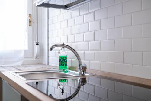 a sink in a kitchen with a faucet at LP Apartments - Navigli in Milan