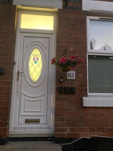 a white door with a window on a brick building at Harcourt Road in Nottingham