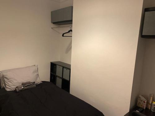 a small bedroom with a bed and a dresser at Harcourt Road in Nottingham