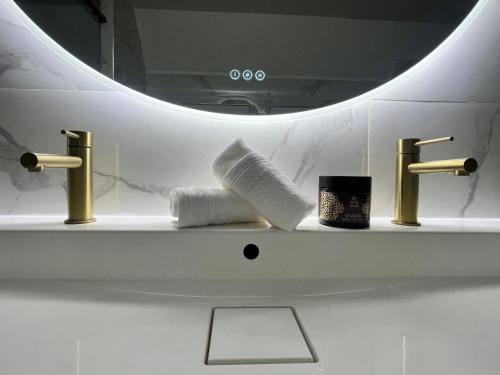 a bathroom sink with two faucets and a towel at Magnifique maison en plein centre ville in Rouen
