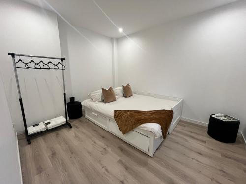 a bedroom with a bed in a white room at Magnifique maison en plein centre ville in Rouen
