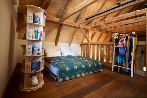 a bedroom with a bed and a book shelf at Ferienhaus Sterntaler mit Sauna in Schwalmstadt