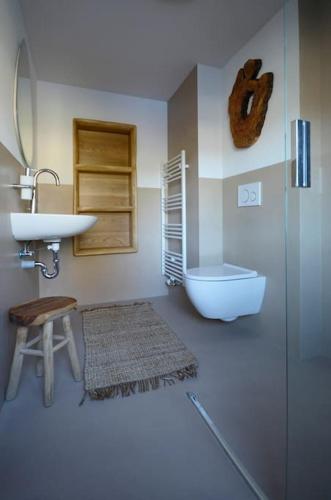 a bathroom with a sink and a toilet at Ferienhaus Sterntaler mit Sauna in Schwalmstadt