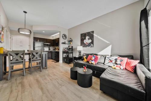 a living room with a black couch and a table at 5 Minutes to Disney Free Shuttle King & queen bed in Orlando