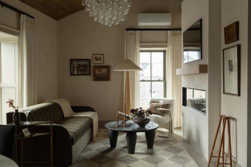 a living room with a couch and a table at Kat Florence Hotels in Elora