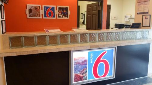 a reception counter with a television in a building at Motel 6-Norman, OK in Norman