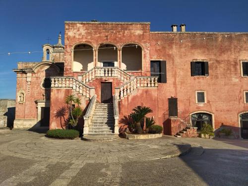 a large red brick building with stairs in front of it at Putignani 210 Apartment in Bari