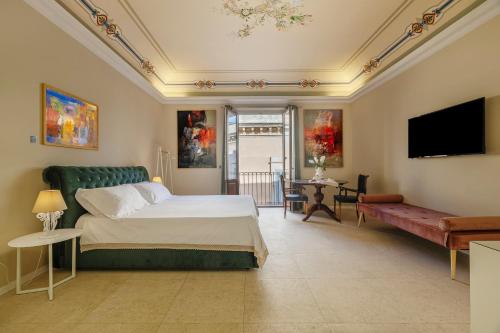 a bedroom with a bed and a flat screen tv at B&B Cantiere dell'anima - Rooms of art in Trapani