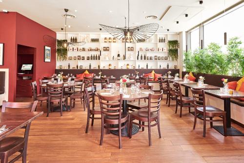 a restaurant with tables and chairs in a room at Luxury Apartment in Olympic Village in London