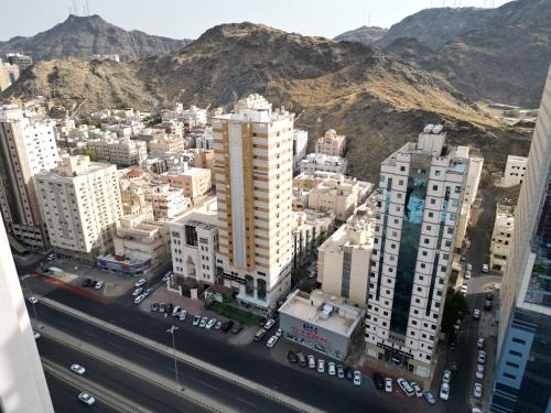 an aerial view of a city with buildings and a highway at فندق زاد المجد مكة الروضة in Makkah