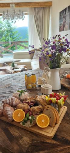 a tray of food on a table with fruit and bread at Chalet Rebeca 6 beds Donovaly in Donovaly
