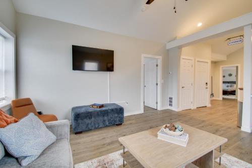 a living room with a couch and a table at Less Than 1 Mi to Lake Ontario Oswego Group Retreat in Oswego