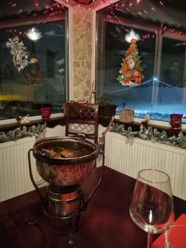 a table with a bowl of food and a wine glass at Pensiunea Alpin Predeal in Predeal
