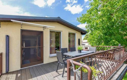 a patio with a table and chairs on a deck at Ferienwohnung Mirow in Mirow