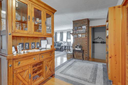 a living room with a large wooden cabinet at Family-Friendly Riverhouse Fishing and Hot Tub in Elizabethton