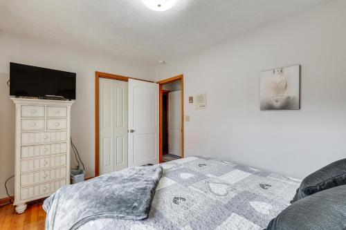 a bedroom with a bed and a flat screen tv at Family-Friendly Riverhouse Fishing and Hot Tub in Elizabethton