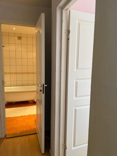 an open door leading to a bathroom with a tub at 2 комнатная квартира в городе Палдиски in Paldiski