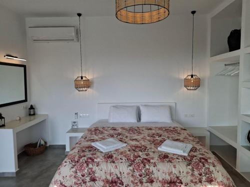 a bedroom with a bed with two towels on it at Sea melody tinos 3 in Agios Sostis