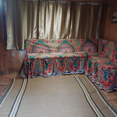 a couch sitting in a room with a rug at Nubian Sandal in Aswan