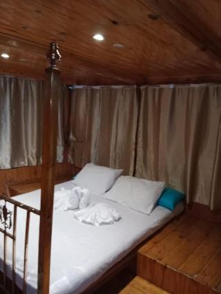 a bedroom with a bed with white sheets and pillows at Nubian Sandal in Aswan