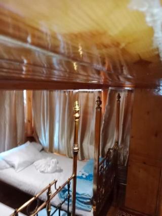 a bedroom with a canopy bed in a room at Nubian Sandal in Aswan
