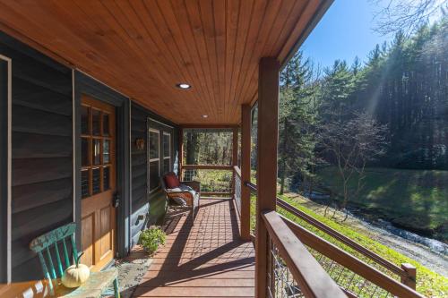 a porch of a house with a wooden ceiling at Hidden Cabin on Old Field Creek in Fleetwood