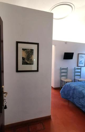 a bedroom with a bed and a picture on a wall at Villa Dei Romani - Country House in Guidonia