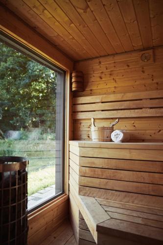 a wooden interior of a sauna with a window at Domki na Kaszubach - nad jeziorem z balią i sauną in Bytów