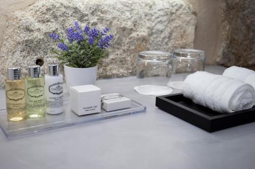 a table with towels and other products on it at Belomont52 Guest House in Porto
