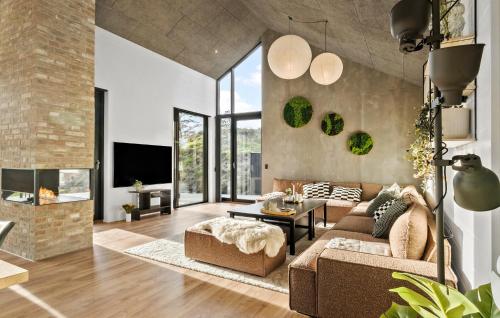 a living room with a couch and a table at 4 Bedroom Pet Friendly Home In Blokhus in Blokhus