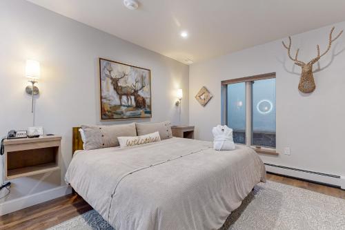 a bedroom with a large bed and a window at Lion Square Lodge South 255, 257 & 261 in Vail