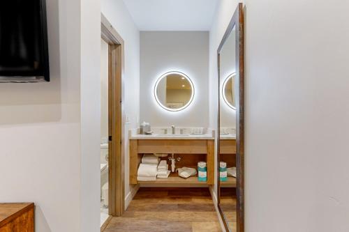 a bathroom with a sink and a mirror at Lion Square Lodge South 255, 257 & 261 in Vail