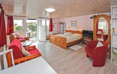 a bedroom with a bed and a living room at Ferienhaus Putbus Auf Rügen in Putbus