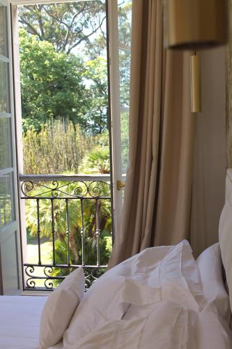 a bed in front of a door with a window at HOTEL BOUTIQUE VILLA DEL MARQUÉS in Muros de Nalón
