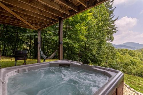 a jacuzzi tub in the backyard of a house at 1 Relaxing Place in Todd