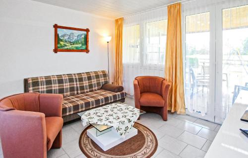 a living room with a couch and chairs and a table at Doppelhaushälfte Blankensee in Wanzka