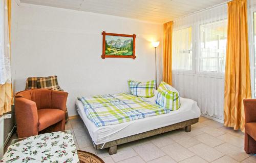 a bedroom with a bed and a chair at Doppelhaushälfte Blankensee in Wanzka