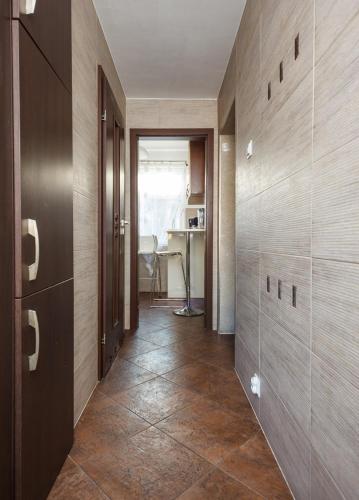 a hallway with wooden walls and a table in a room at Plac Uniwersytecki 15B in Wrocław